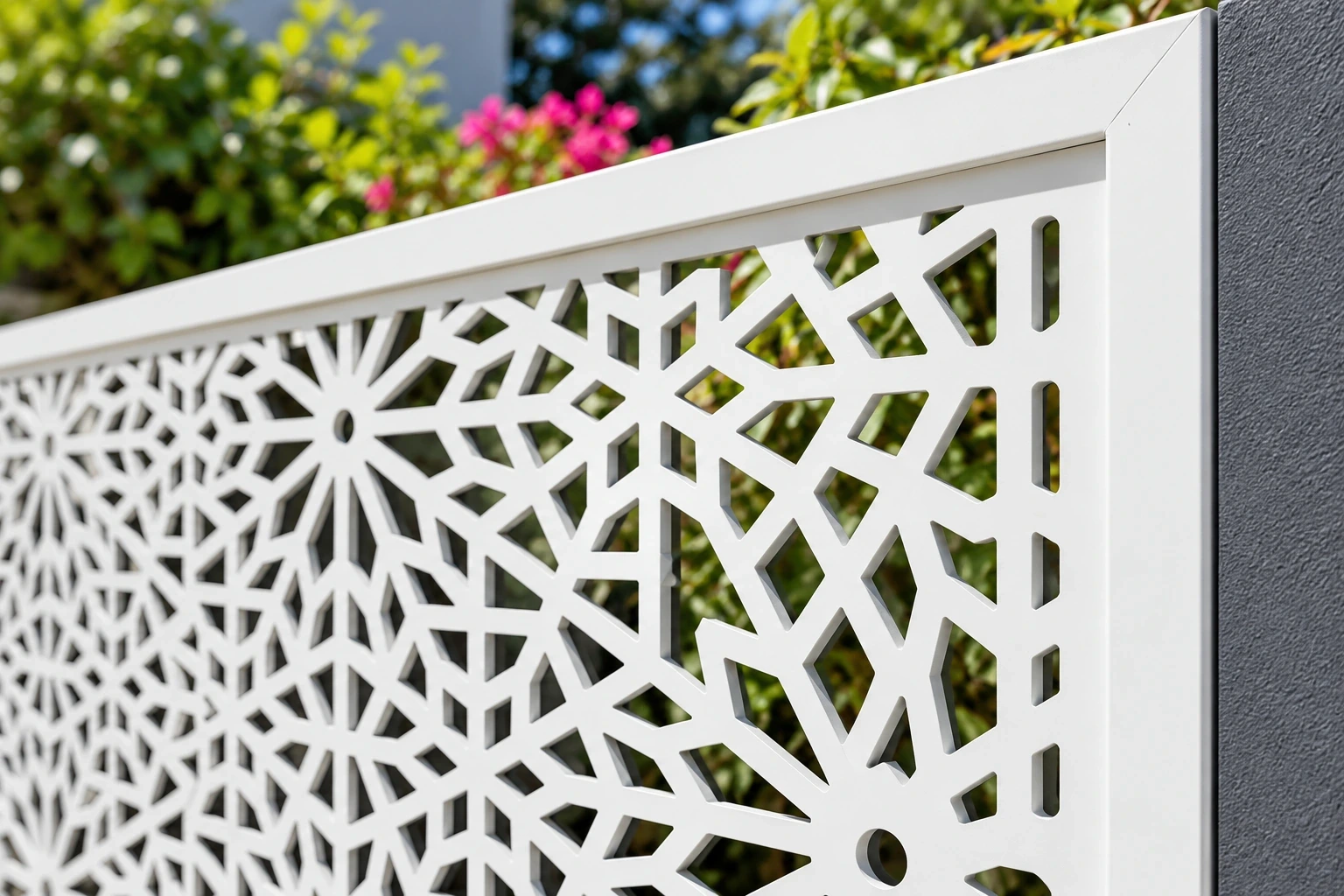 Close view of white composite rosette-pattern openings meeting a rectangular frame